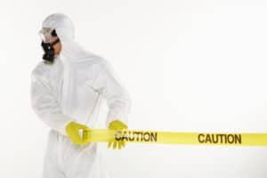 This man in a hazmat suit rolling out caution tape might recommend starting your business during a pandemic. 