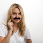 This woman with a fake mustache wonders if she's good enough to write a book.